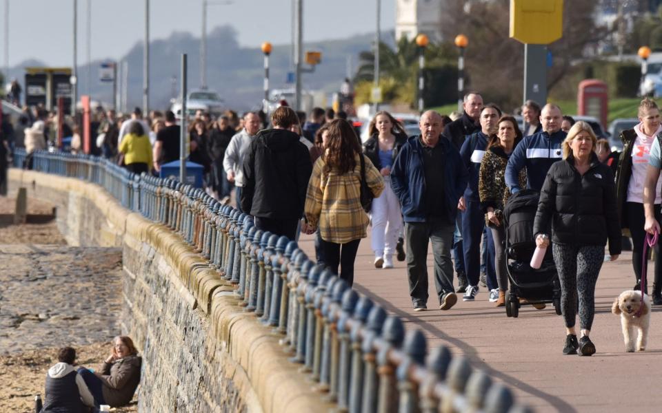 SOUTHEND, ENGLAND - FEBRUARY 21: People walk beside the beach on a warm sunny day as the weather warms for the week ahead on February 21, 2021 in Southend, England. Temperatures are predicted to rise to 18C for parts of the UK this week as a hot air plume is set to arrive from the Canary islands. After a surge of covid-19 cases, fueled partly by a more infectious variant of the virus, the British government had reimposed nationwide lockdown measures across England. A review was held on February 15 and despite deaths and infections falling, lockdown will continue. - John Keeble/Getty Images