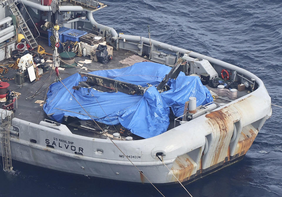 An aerial photo shows an object believed to be part of the US V-22 Osprey, which crashed on Nov. 29, on a U.S. salvage vessel in Yakushima Town, Kagoshima Prefecture in December 2023.  (Kota Kiriyama / The Yomiuri Shimbun via AP)