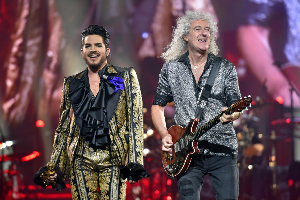 FILE - Adam Lambert, left, and Brian May of Queen + Adam Lambert perform in Chicago on Aug. 9, 2019. The band is hitting the road this fall for a North American expansion of their Rhapsody Tour. The tour will make 14 stops throughout the U.S. and Canada, including shows in New York, Boston, Toronto, Chicago, Nashville and Dallas, before closing out at Los Angeles in November. (Photo by Rob Grabowski/Invision/AP, File)