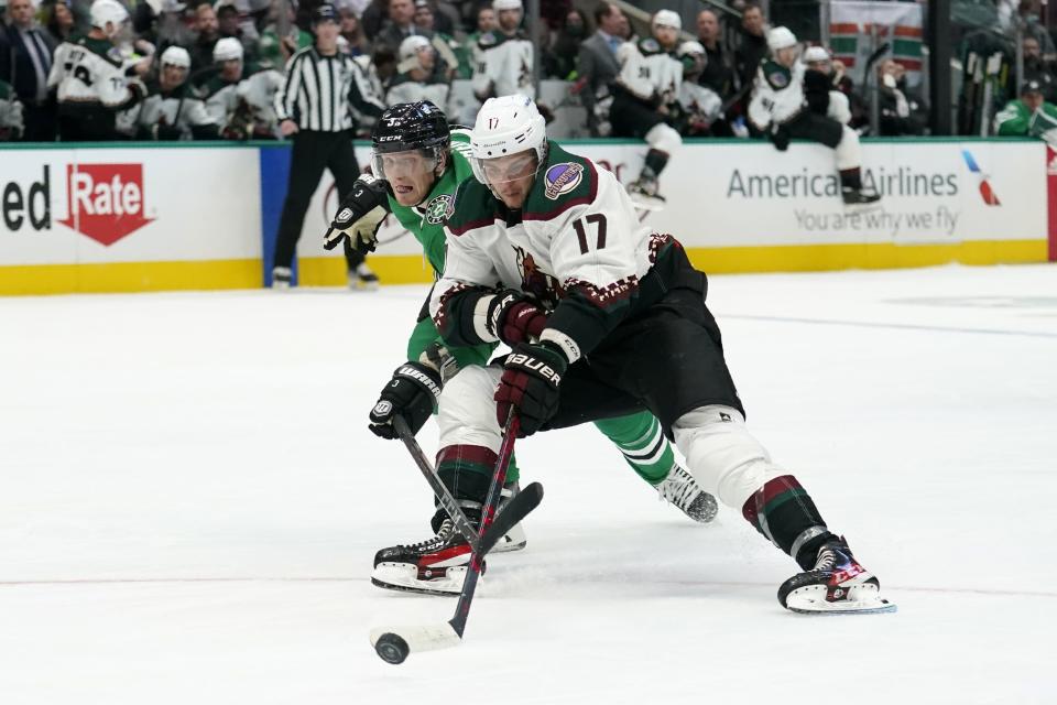 Dallas Stars defenseman John Klingberg (3) defends as Arizona Coyotes center Alex Galchenyuk (17) attempts to control the puck on an attack in the second period of an NHL hockey game in Dallas, Monday, Dec. 6, 2021. (AP Photo/Tony Gutierrez)