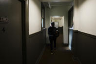 Sarah Holland, senior director of supportive housing and employment at Central City Concern, a Portland-based homeless services nonprofit, looks out the window after walking by a shared bathroom at one of their affordable housing properties on Friday, March 15, 2024, in Portland, Ore. The nonprofit leases more than 1,000 single room occupancy units, both subsidized and not, to people who are considered extremely low-income. It helps people struggling to access housing due to things like eviction histories and poor credit scores. (AP Photo/Jenny Kane)