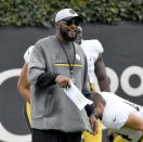 Pittsburgh Steelers coach Mike Tomlin talks to players as they stretch during NFL football practice Wednesday, Oct. 13, 2021, in Pittsburgh. (Matt Freed/Pittsburgh Post-Gazette via AP)