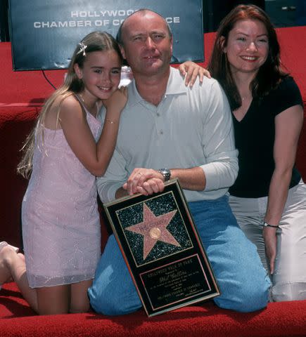 <p>Ron Galella, Ltd./Ron Galella Collection/Getty </p> Phil Collins with his daughters Lily Collins and Joely Collins attend his Walk of Fame Star ceremony in 1999