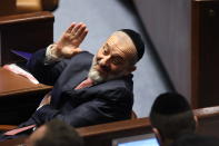 Member of Knesset Aryeh Deri waves during the swearing-in ceremony for Israeli lawmakers at the Knesset, Israel's parliament, in Jerusalem, Tuesday, Nov. 15, 2022. Israeli lawmakers were sworn in at the Knesset, on Tuesday, following national elections earlier this month. (Abir Sultan/Pool Photo via AP)