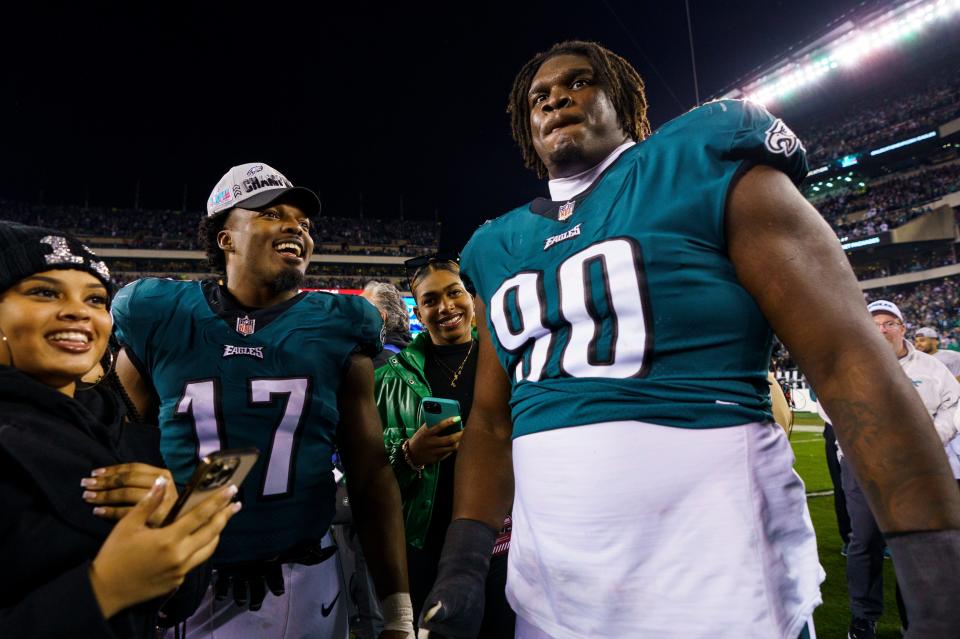 Philadelphia Eagles defensive tackle Jordan Davis (90) celebrates the win with linebacker Nakobe Dean (17) following the NFC championship game against the San Francisco 49ers on Sunday, Jan. 29, 2023, in Philadelphia.