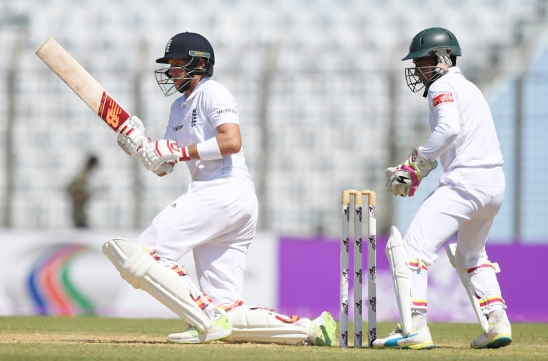 England's Joe Root plays a shot in front of Bangladesh' captain Mushfiqur Rahim during the first day of their first Test match, at Zahur Ahmed Chowdhury Cricket Stadium in Chittagong, on October 20, 2016