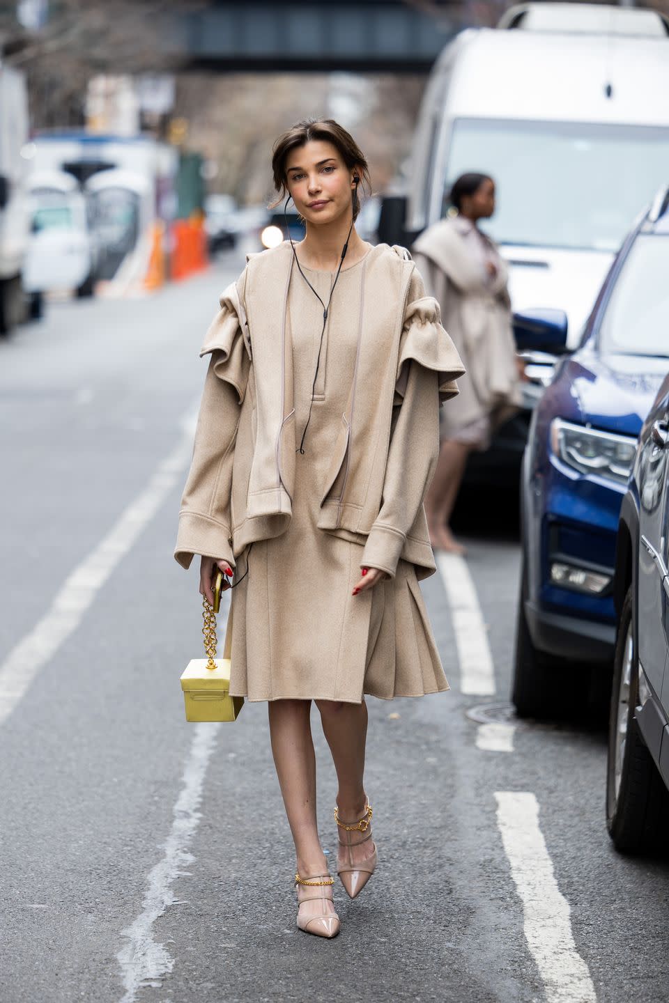 new york, new york february 12 charlotte briar d’alessio wears beige dress, jacket, yellow bag, pointed heels outside adeam during new york fashion week on february 12, 2023 in new york city photo by christian vieriggetty images