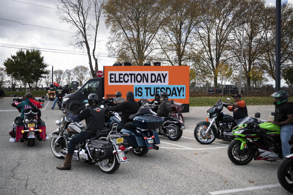 A truck illuminated with a sign reading "Election Day is Tuesday," is set to convoy with motorcyclists during a "Black Bikers Vote" rally, Saturday, Nov. 5, 2022, in Philadelphia. (AP Photo/Joe Lamberti)