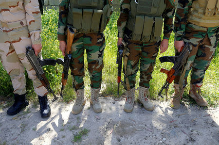 Female Peshmerga fighters hold their weapons at a site during a deployment near the frontline of the fight against Islamic State militants in Nawaran near Mosul, Iraq, April 20, 2016. REUTERS/Ahmed Jadallah