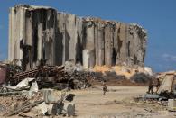 Members of the Lebanese army walk near the damaged grain silo during a joint effort with the French military to clear the rubble from port of Beirut