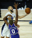 Orlando Magic's Evan Fournier scores against Philadelphia 76ers' Josh Richardson (0) during the second half of an NBA basketball game Friday, Aug. 7, 2020, in Lake Buena Vista, Fla. (Kevin C. Cox/Pool Photo via AP)