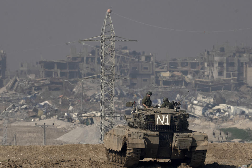 Israeli soldiers overlook the Gaza Strip from a tank, as seen from southern Israel, Friday, Jan. 19, 2024. (AP Photo/Maya Alleruzzo)