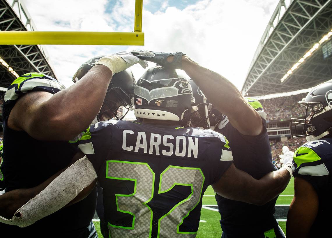 Seattle Seahawks running back Chris Carson (32) celebrates a touchdown run with Seattle Seahawks offensive tackle George Fant (74) and Seattle Seahawks wide receiver Jaron Brown (18) during the second quarter. The Seattle Seahawks played the Cincinnati Bengals in an NFL game at CenturyLink Field in Seattle, Wash., on Sunday, Sept. 8, 2019.