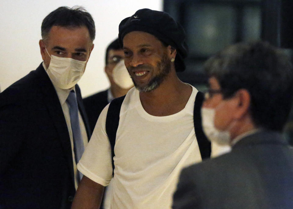 Former Brazilian soccer star Ronaldinho arrives at a hotel where he is to stay under house arrest in Asuncion, Paraguay, Tuesday, April 7, 2020. Ronaldinho and his brother Roberto De Assis Moreira spent a month in jail accused of entering Paraguay with fake passports. (AP Photo/Jorge Saenz)