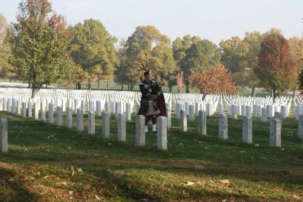 A bagpiper plays at Arlington National Cemetery, Section 60.