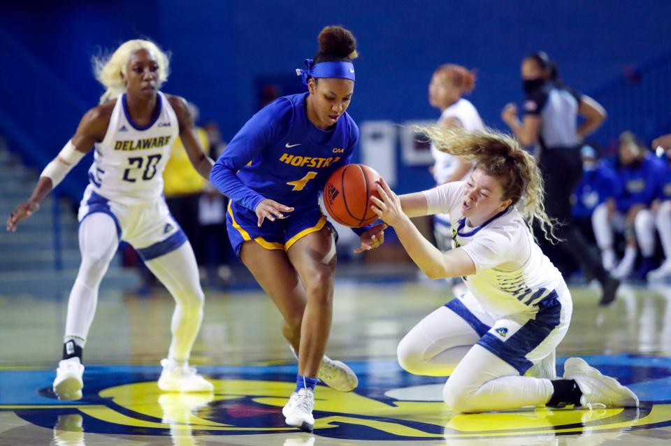 Delaware's Lizzie Oleary (right) and Hofstra's Rosi Nicholson scramble for a loose ball as Blue Hen Jasmine Dickey moves in during the first half of Delaware's 73-38 win at the Bob Carpenter Center, Friday, January 14, 2022.