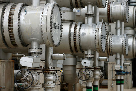 Pipes and valves are pictured at the refinery of Austrian oil and gas group OMV in Schwechat, Austria, October 21, 2015. REUTERS/Heinz-Peter Bader/File Photo