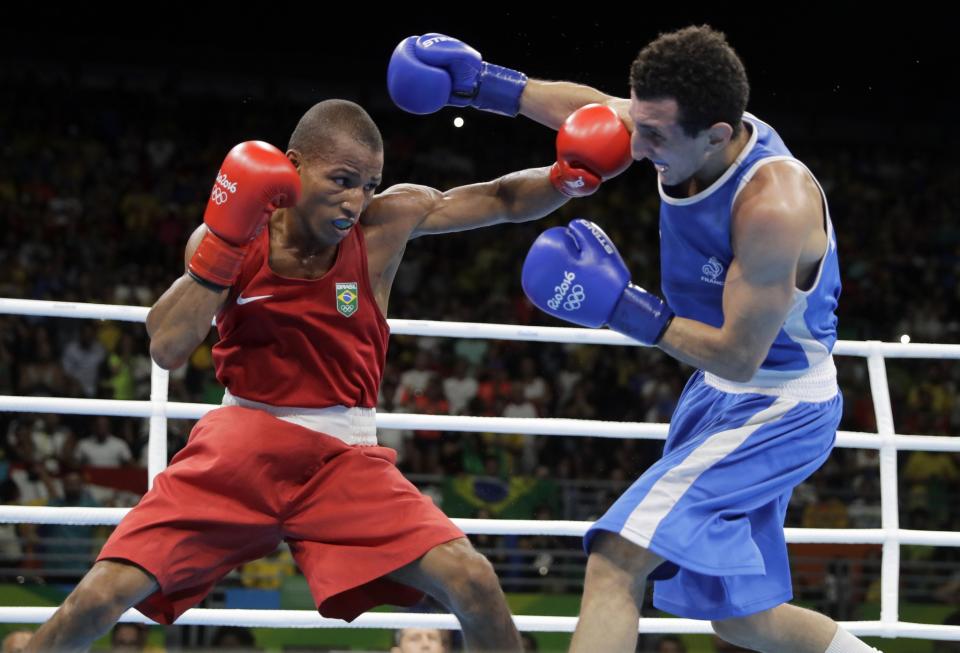 Brazil's Robson Conceicao, left, fights France's Sofiane Oumiha during a men's lightweight 60-kg final boxing match at the 2016 Summer Olympics in Rio de Janeiro, Brazil, Tuesday, Aug. 16, 2016. (AP Photo/Jae C. Hong)