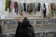 An Iranian woman weaves a carpet at a workshop in the city of Kashan, about 152 miles (245 km) south of the capital Tehran, Iran, Tuesday, April 30, 2024. (AP Photo/Vahid Salemi)