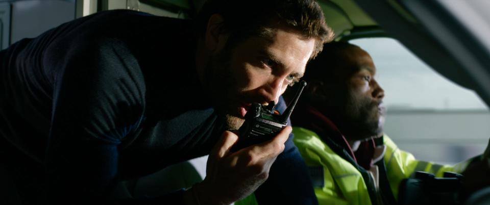 Adoptive brothers Danny (Jake Gyllenhaal, left) and Will (Yahya Abdul-Mateen II) hijack an emergency vehicle after a bank heist goes bust in "Ambulance."