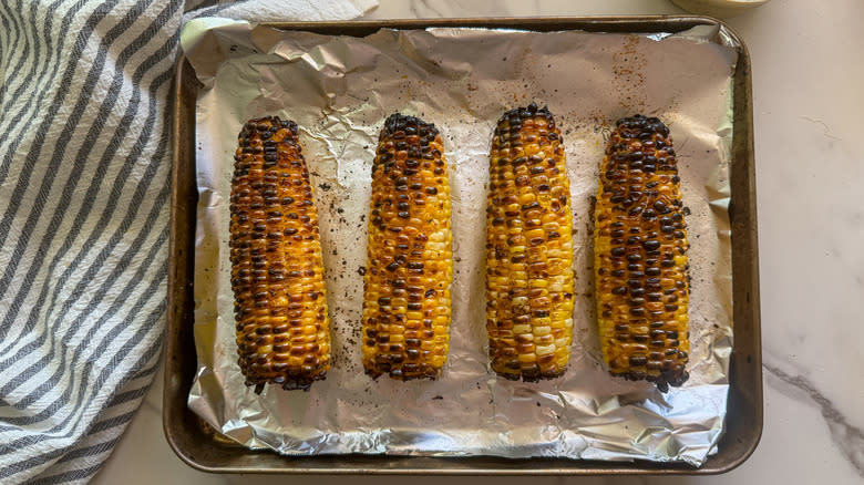 charred corn on baking sheet