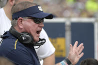 Notre Dame head coach Brian Kelly talks to players on the bench during the first half of the Camping World Bowl NCAA college football game against Iowa State Saturday, Dec. 28, 2019, in Orlando, Fla. (AP Photo/Phelan M. Ebenhack)