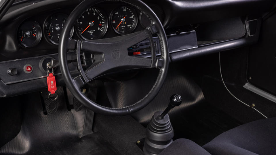 The steering wheel and dashboard inside a 1973 Porsche 911 Carrera RS 2.7 Homologation.