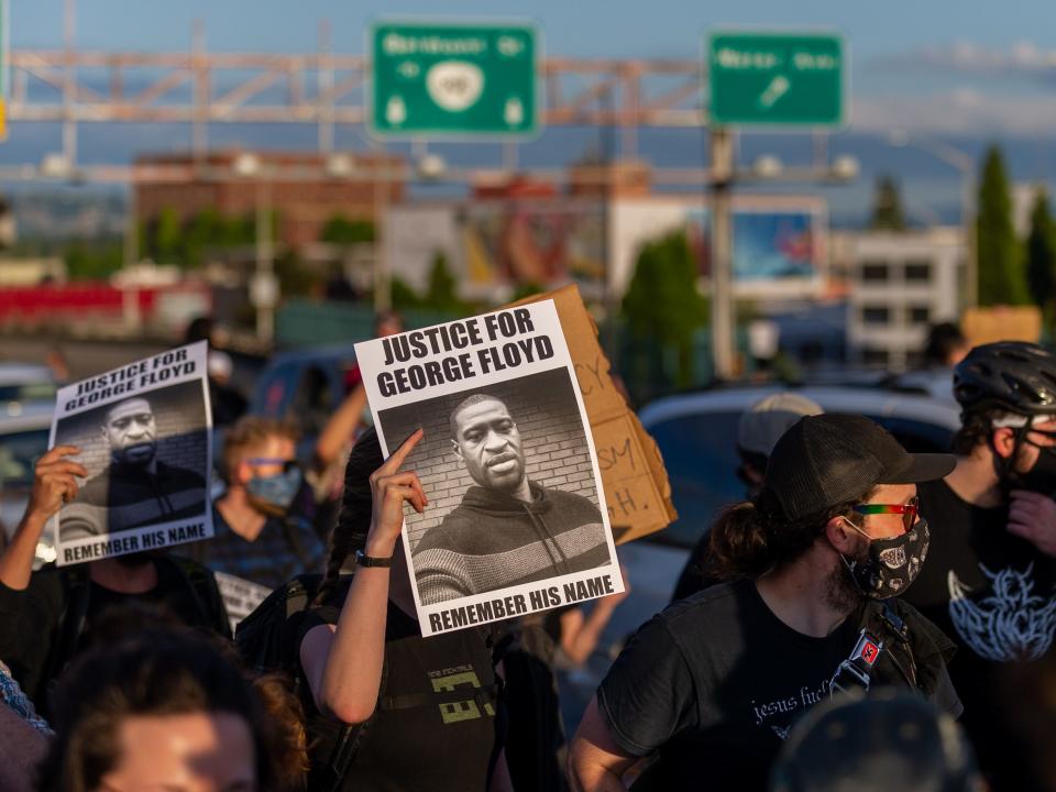 A sign calls for justice for George Floyd as the several thousand strong march walks on in direction of downtown Portland, OR, on June 3, 2020. The protest was organized to voice concerns over police brutality in the aftermath of the recent death of George Floyd, an African-American man from Minnesota, who died in police custody on May 25, 2020.