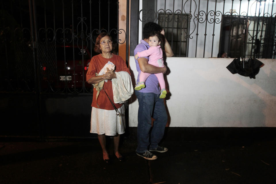 People stand outside their house in Managua after an earthquake shook Nicaragua October 13, 2014. (REUTERS/Oswaldo Rivas)