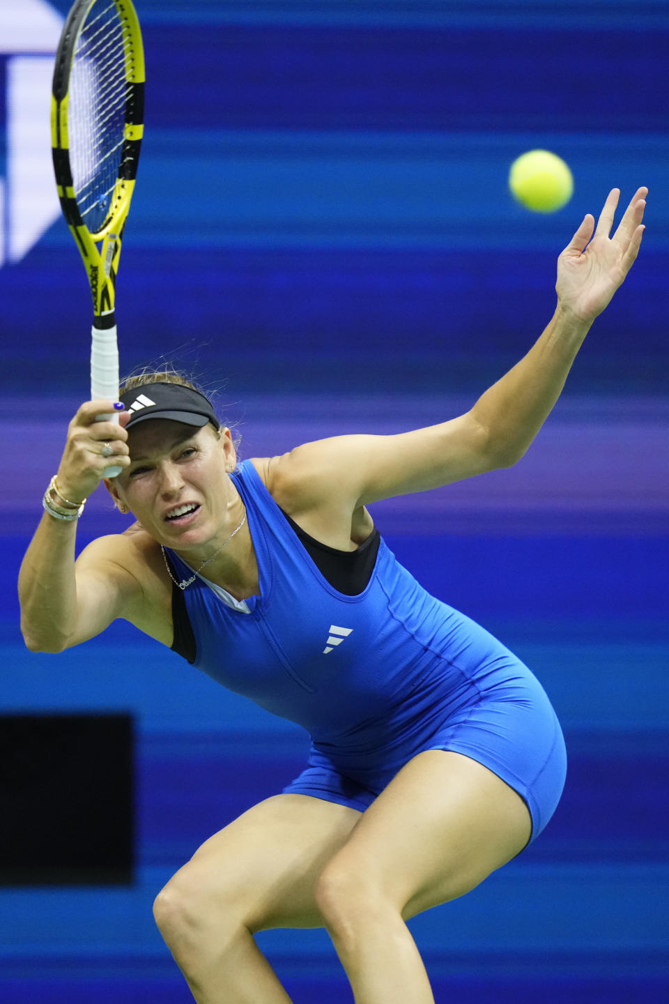 Caroline Wozniacki, of Denmark, returns a shot to Petra Kvitova, of the Czech Republic, during the second round of the U.S. Open tennis championships, Wednesday, Aug. 30, 2023, in New York. (AP Photo/Frank Franklin II)