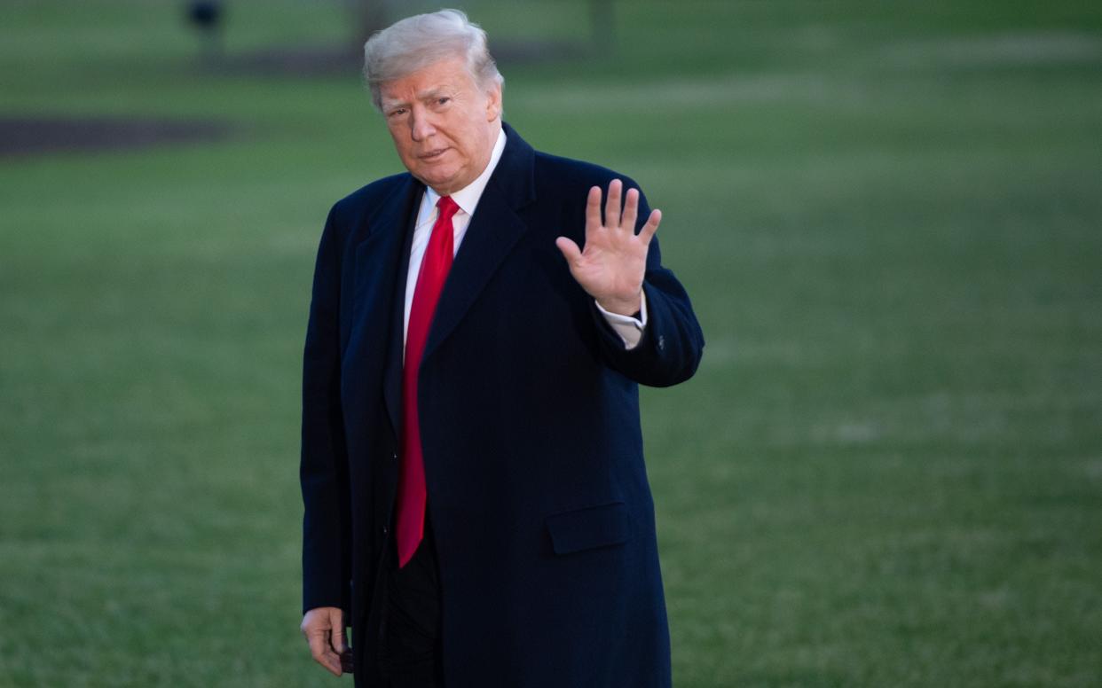 President Donald Trump is pictured walking from Marine One after arriving on the South Lawn of the White House in Washington, DC.