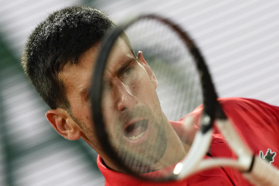 Serbia's Novak Djokovic plays a shot against Japan's Yoshihito Nishioka during their first round match at the French Open tennis tournament in Roland Garros stadium in Paris, France, Monday, May 23, 2022. (AP Photo/Michel Euler)