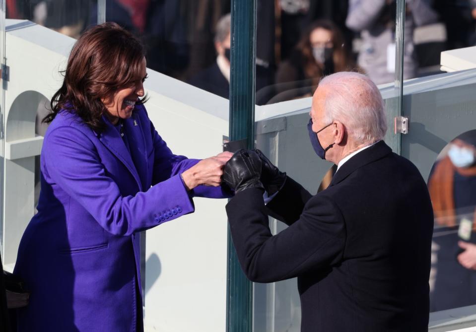 Vice President Kamala Harris bumps fists with President-elect Joe Biden after being sworn in during the inauguration.