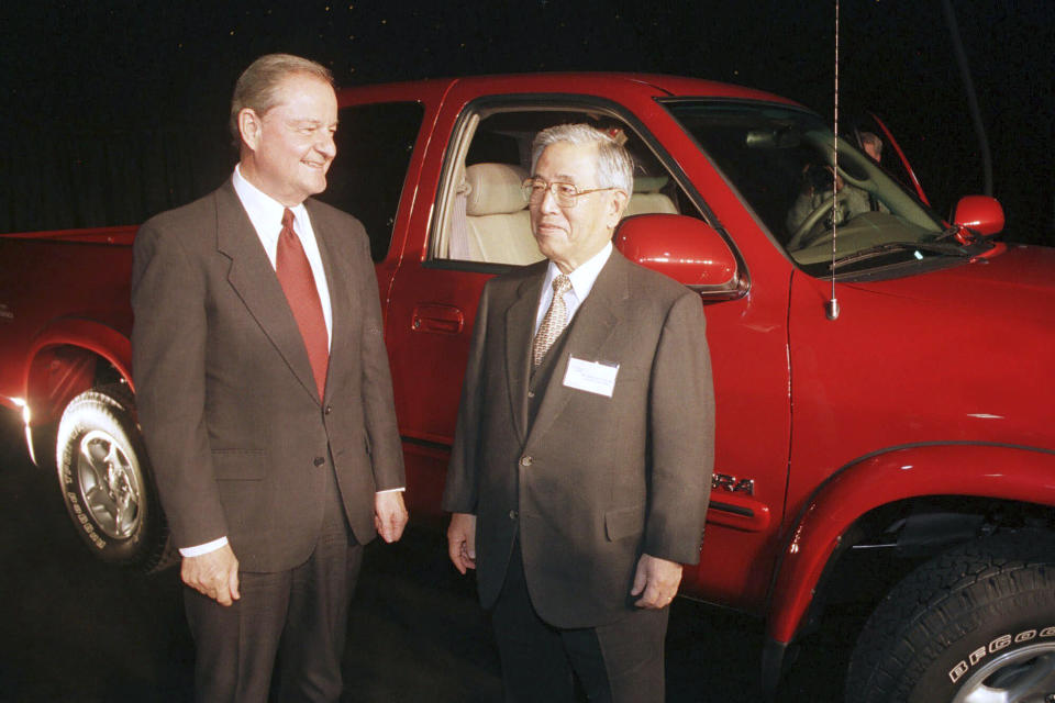 FILE - Indiana Gov. Frank O'Bannon and Toyota Chairman Shoichiro Toyoda, right, pose Thursday, Dec. 10, 1998, in front of the new Tundra full-sized pickup truck to be produced at the new plant near Princeton in southwest Indiana. Shoichiro Toyoda, who as a son of the company's founder oversaw Toyota's expansion into international markets has died. He was 97. (AP Photo/Chuck Robinson, File)