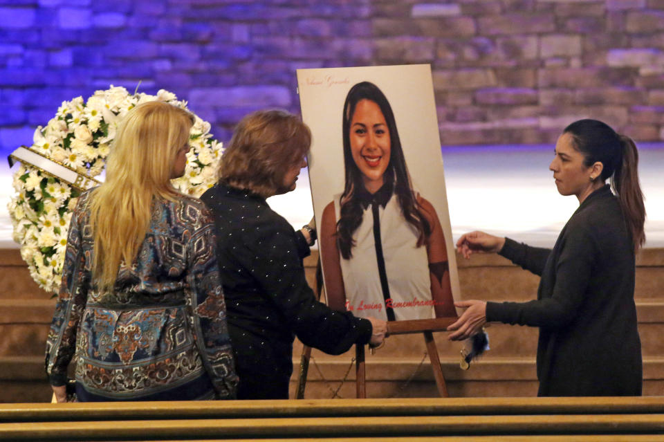 Women set up a picture of Paris attack victim Nohemi Gonzalez for her funeral service at the Calvary Chapel in Downey, Calif., on Dec. 4, 2015.  (Genaro Molina / Pool via AP)