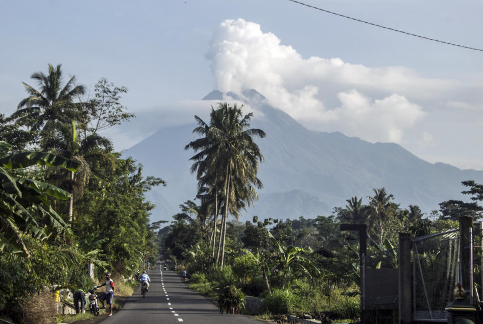 Mount Merapi spews volcanic steam from its crater seen from Sleman, Yogyakarta, Indonesia, Thursday, Jan. 7, 2021. The 2,968-meter (9,737-foot) mountain spewed avalanches of hot clouds on Thursday morning amid its increasing volcanic activities. (AP Photo/Slamet Riyadi)