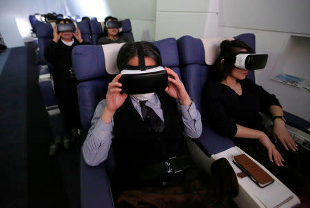 Guests wearing virtual reality (VR) goggles are seen at the "First Airlines", virtual first-class airline experience facility in Tokyo, Japan February 14, 2018. Picture taken February 14, 2018. REUTERS/Toru Hanai