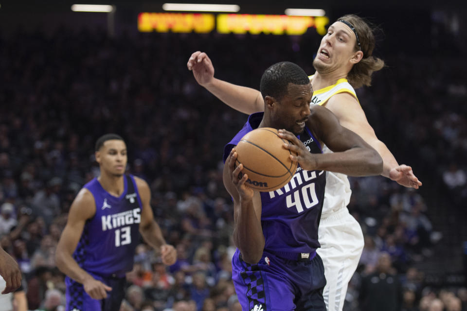 Utah Jazz forward Kelly Olynyk defends against Sacramento Kings forward Harrison Barnes (40) as forward Keegan Murray (13) watches during the first quarter of an NBA basketball game in Sacramento, Calif., Saturday, Dec. 16, 2023. (AP Photo/José Luis Villegas)