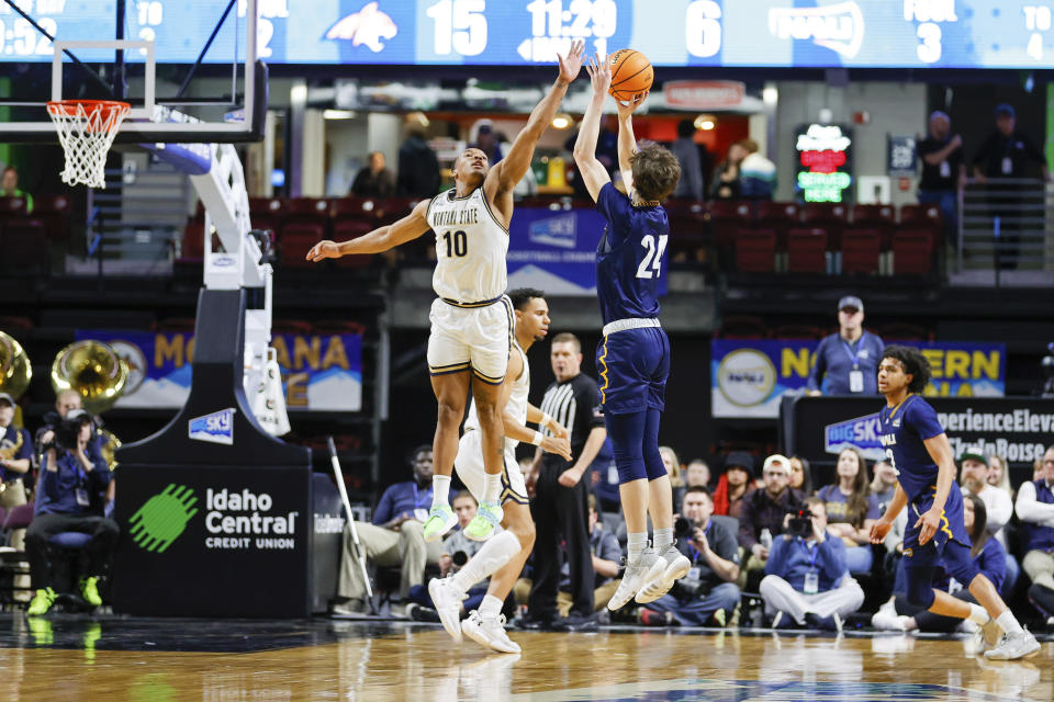 Northern Arizona guard Trenton McLaughlin (24) puts up a three point shot over top of Montana State guard Darius Brown II (10) in the first half of an NCAA college basketball game for the championship of the Big Sky men's tournament in Boise, Idaho, Wednesday, March 8, 2023. (AP Photo/Steve Conner)