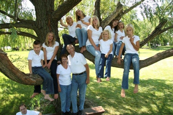 Richard Johnson and his wife, Marjorie, pose for a photo with their grandchildren in 2009. Left to right: Kirk Leach, Kerrie (Thompson) Knudsen, Marjorie and Richard Johnson, Ann (Houlette) Wheeler, Melanie (Leach) Vespestad, Kristin (Thompson) Griffin, Stephanie Houlette, Bethany (Leach) Ogle, Renee Houlette and Kacie Thompson.