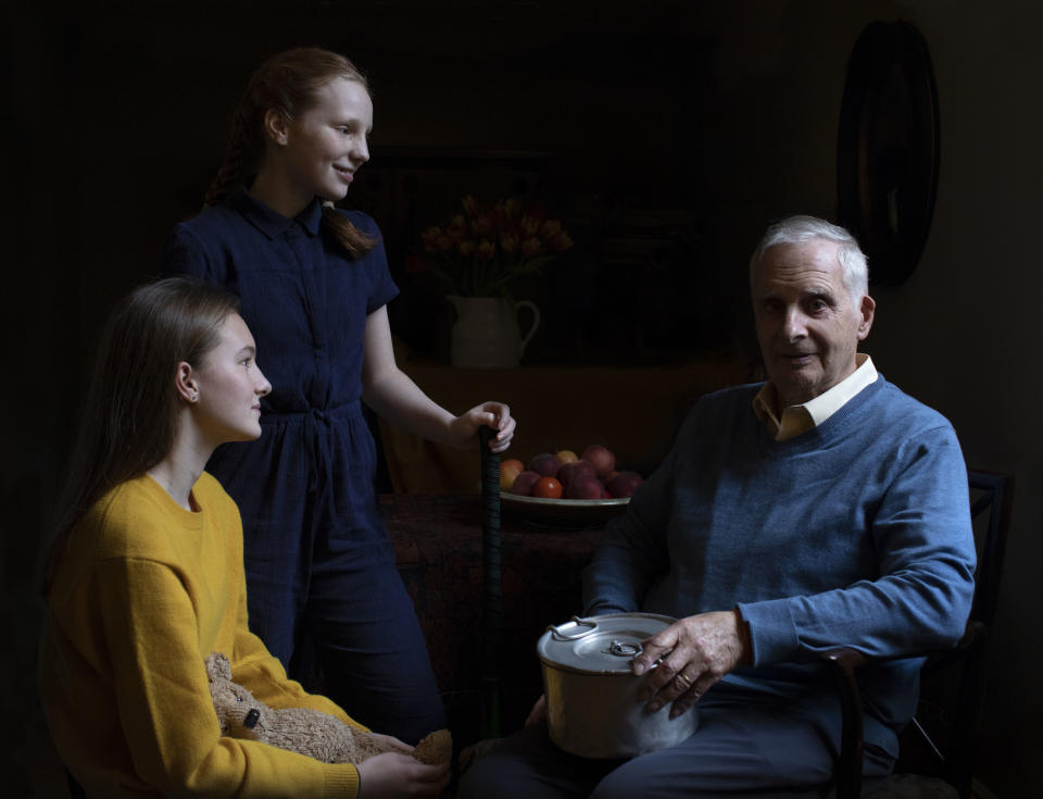 In this photo taken by Britain's Kate, Duchess of Cambridge and made available on Sunday Jan. 26, 2020, Steven Frank BEM, aged 84, originally from Amsterdam, who survived multiple concentration camps as a child, is pictured alongside his granddaughters Maggie and Trixie Fleet, aged 15 and 13. (The Duchess of Cambridge via AP)