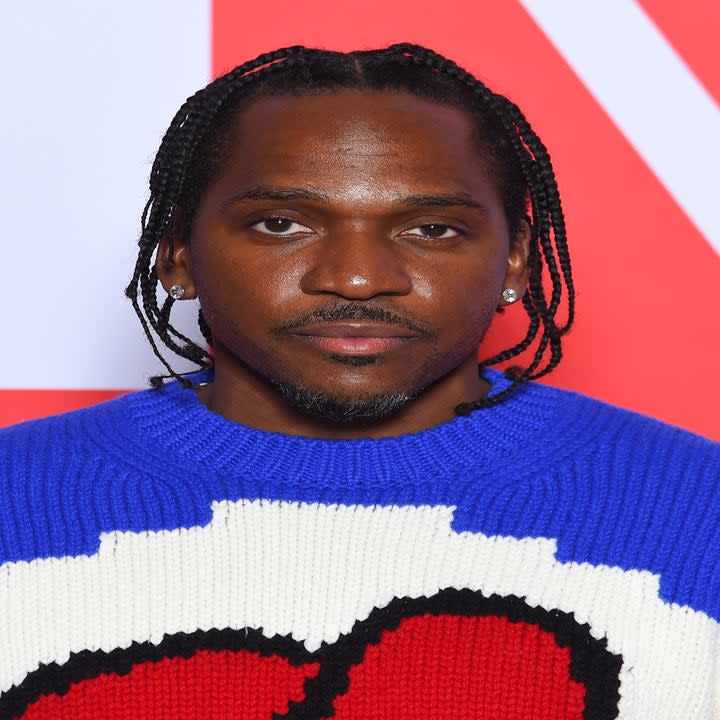 Pusha T in a bright blue and red sweater on the red carpet