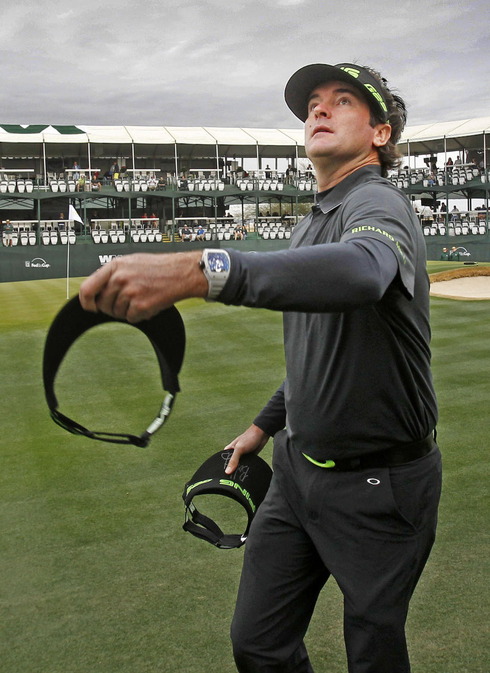 Bubba Watson throws visors to fans on the 16th hole during the second round of the Phoenix Open golf tournament on Friday, Jan. 31, 2014, in Scottsdale, Ariz. (AP Photo/The Arizona Republic, David Kadlubowski) MARICOPA COUNTY OUT; NO SALES