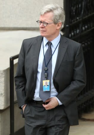 White House legal counsel Flood exits the Eisenhower Executive Office Building on the White House campus in Washington