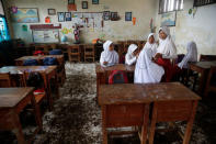 Students gather in a classroom in Pantai Bahagia village in Bekasi, West Java province, Indonesia, January 22, 2018. REUTERS/Beawiharta