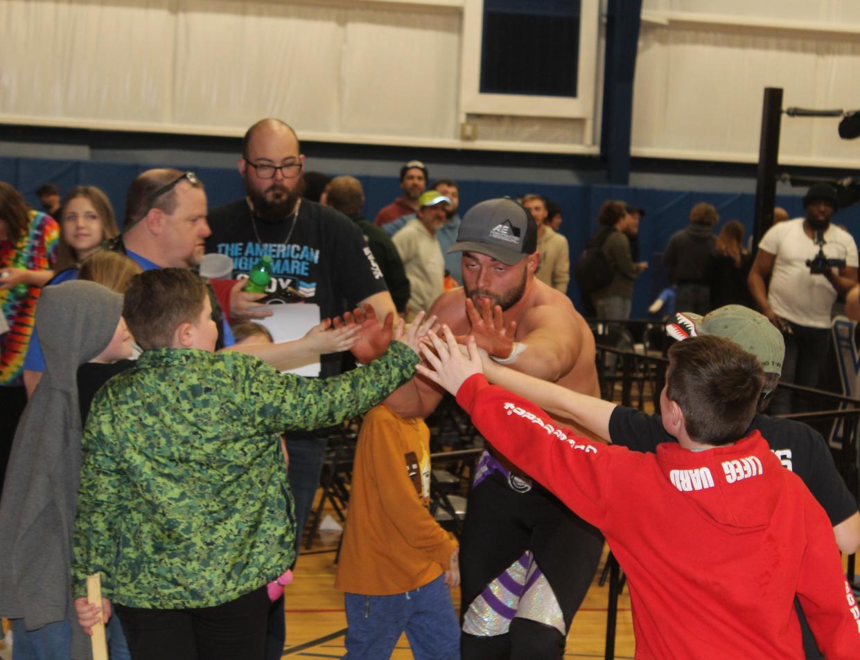 Chael Connors of Hornell high-fives the hometown fans after his match with Griffin McCoy during Xcite Wrestling's first-ever event in Hornell Saturday, March 30, 2024 at the YMCA.