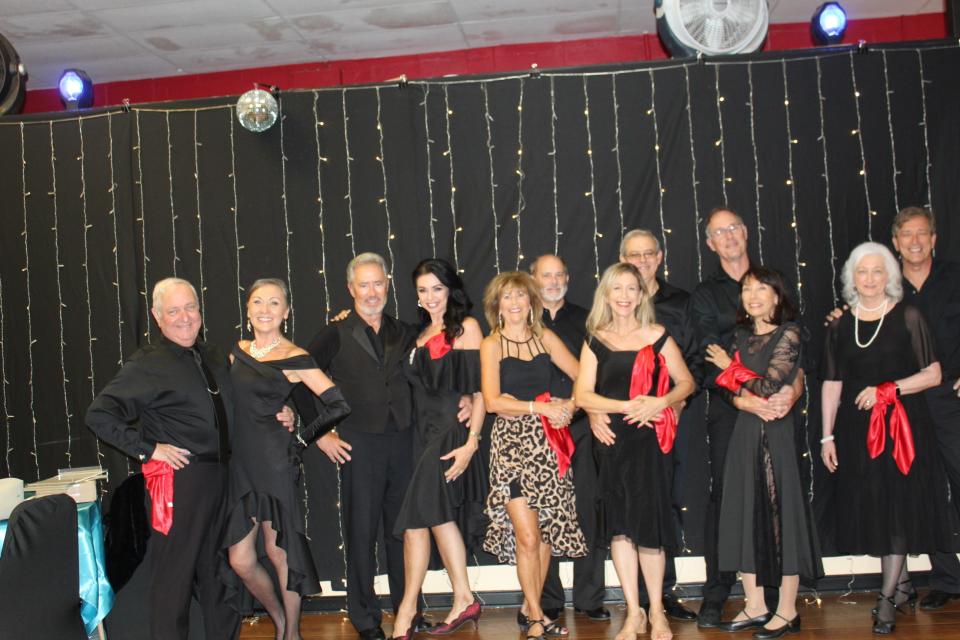 Dancers pose for the camera Sept. 16 during Cape Coral-Fort Myers USA Dance's celebration of National Ballroom Dance Week. The dance at Cape Coral's Rhythm in Motion Dance Studio was sold-out.