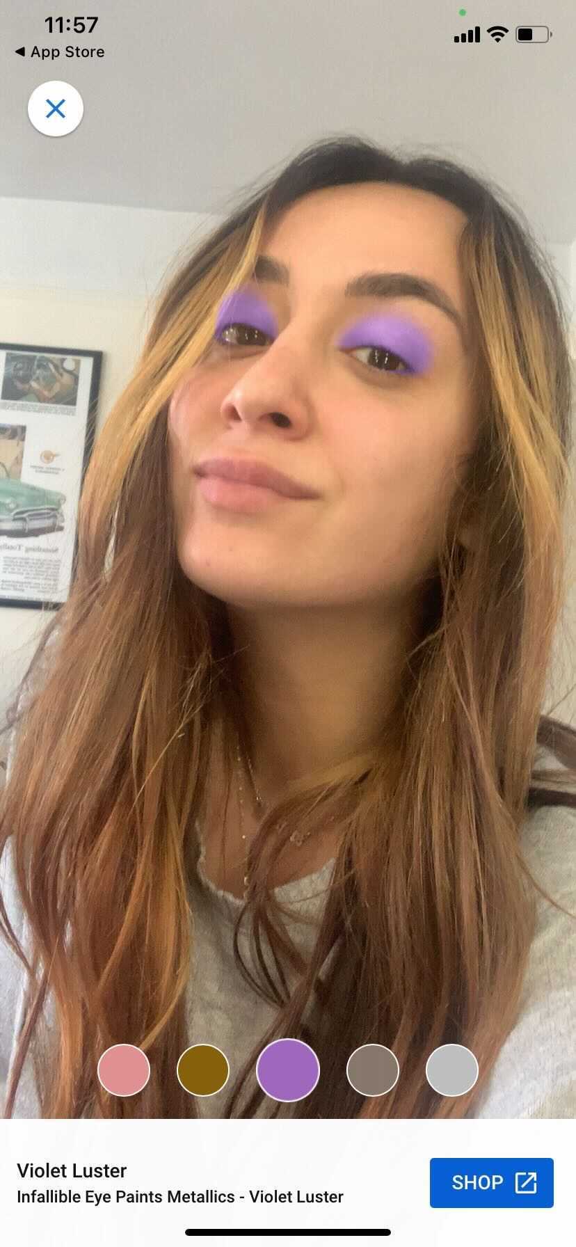 Commerce writer Angela Trakoshis trying on a purple eye shadow.