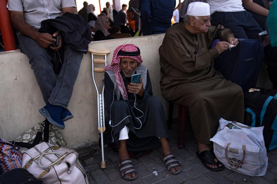 Palestinians wait to cross into Egypt at the Rafah border crossing in the Gaza Strip (Copyright 2023 The Associated Press. All rights reserved.)