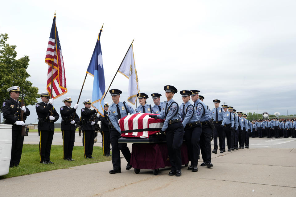 Members of an honor guard move the casket of Minneapolis police Officer Jamal Mitchell into Maple Grove Senior High School for his public memorial service, Tuesday, June 11, 2024, in Maple Grove, Minn. Mitchell was shot and killed while responding to a shooting on May 30, 2024. (AP Photo/Abbie Parr, Pool)